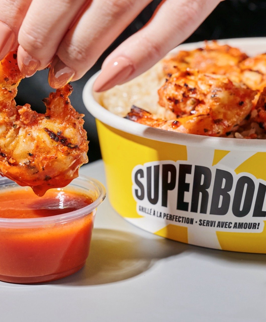 A branded Superbol food bowl with food.